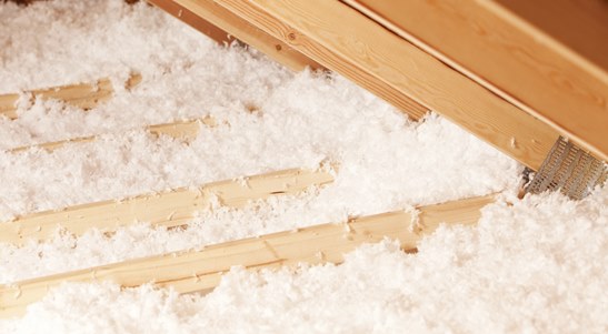 Loose-fill, blown-in fiberglass insulation in an attic.