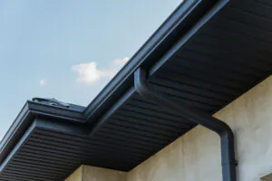 Black seamless gutters against blue sky